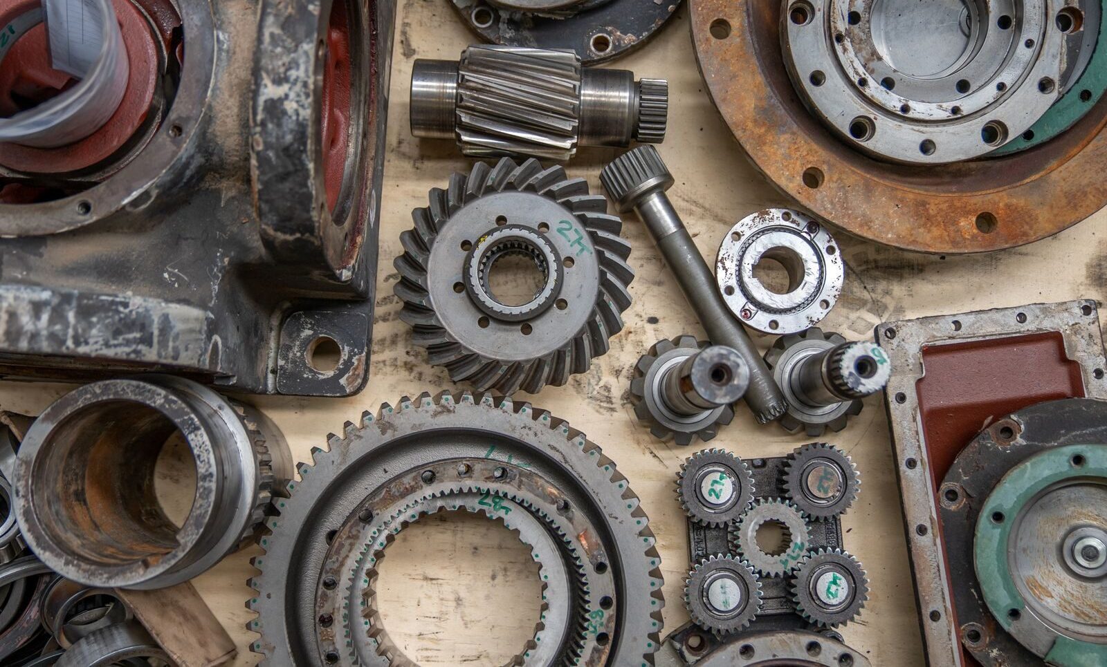 Detailed shot of industrial gears and mechanical parts in a workshop setting.