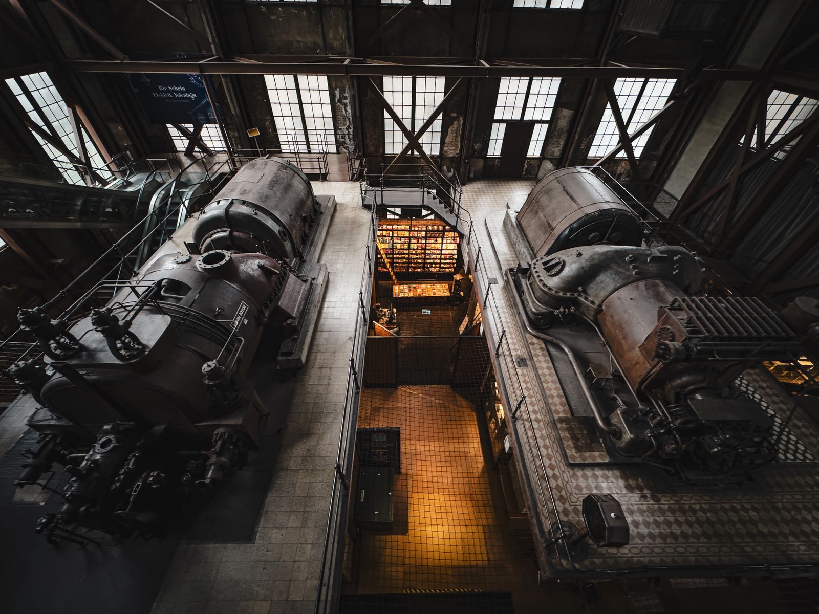 Overhead view of vintage industrial machinery inside a historic factory setting.