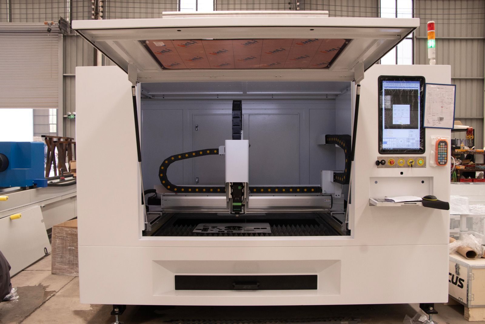 A high-tech CNC machine open in a modern industrial workshop setting, ready for precision work.